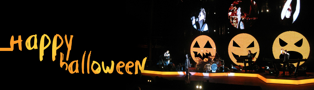 Depeche Mode on stage, with Jack-o-lanterns on the video screens.